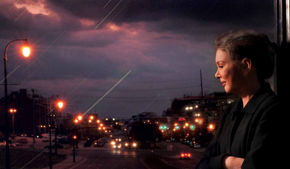Nanci Griffith standing on a dark street