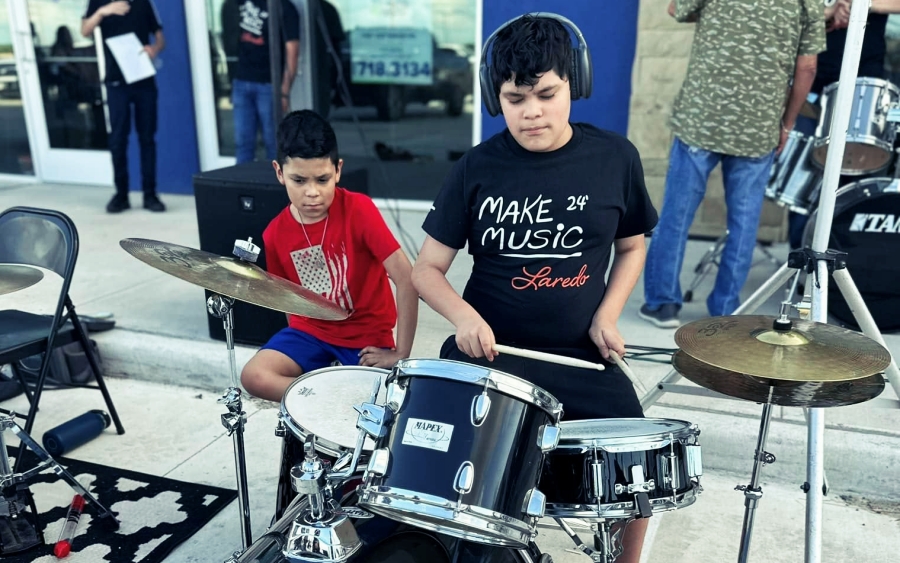 kids drumming outside Second Chance Music