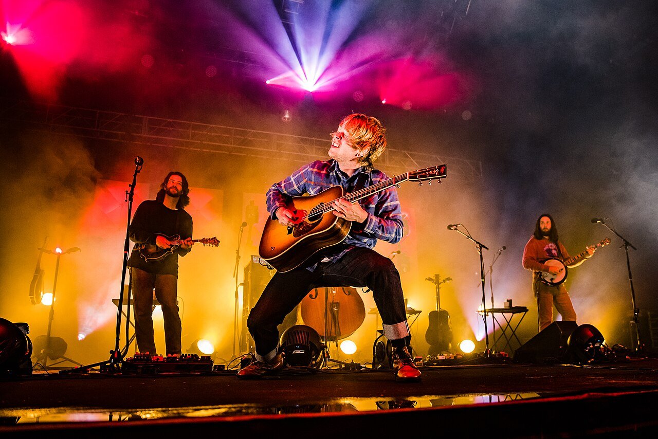 Billy Strings playing guitar on stage in 2021