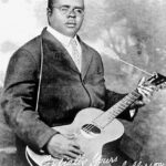 Portrait of Blind Lemon Jefferson holding guitar, signed Cordially Yours Blind Lemon Jefferson