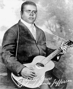 Portrait of Blind Lemon Jefferson holding guitar, signed Cordially Yours Blind Lemon Jefferson