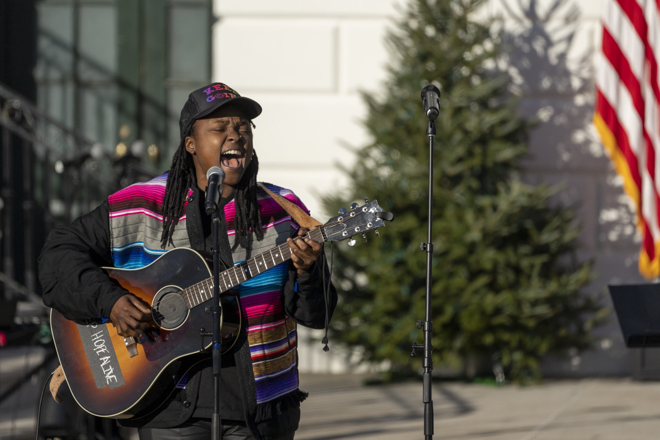 Joy Oladokun performing with guitar