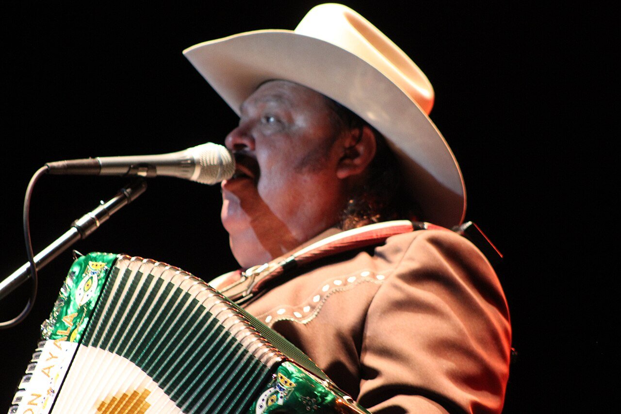 Ramón Ayala playing accordion on stage in 2012